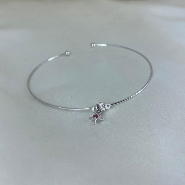 Silver bracelet with a small charm
