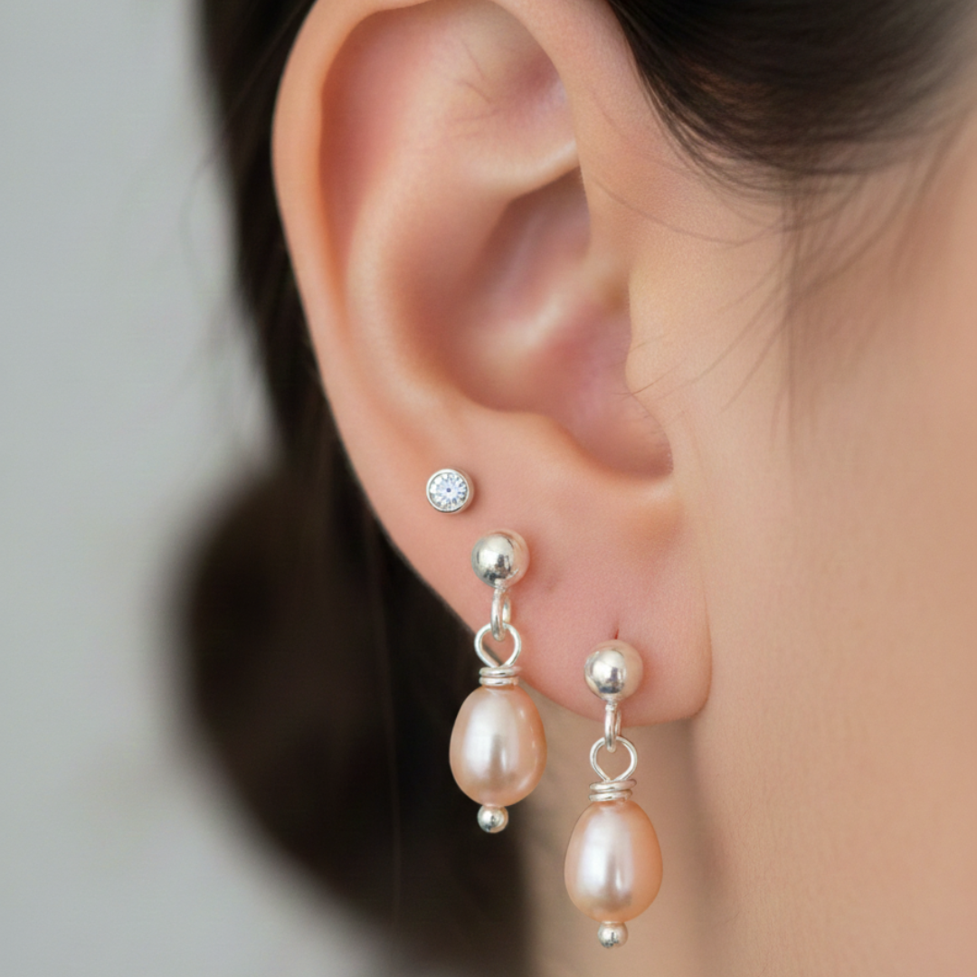 Close-up of an ear wearing pearl earrings 