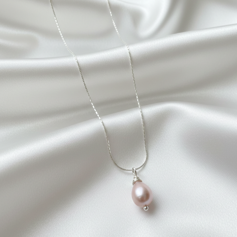 Pearl necklace on a white fabric background